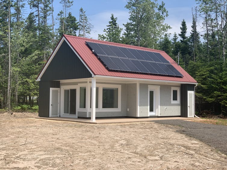 Недавно построенный пассивный дом с солнечными батареями на крыше